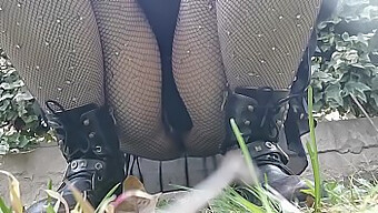 Watch A Sexy Brunette In Fishnet Stockings Get Wet In Public